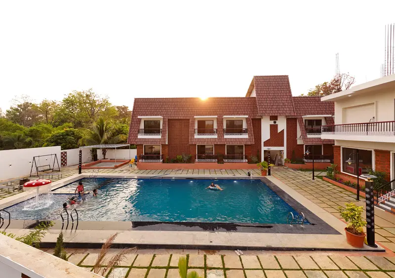The pool courtyard and cottages at sunset